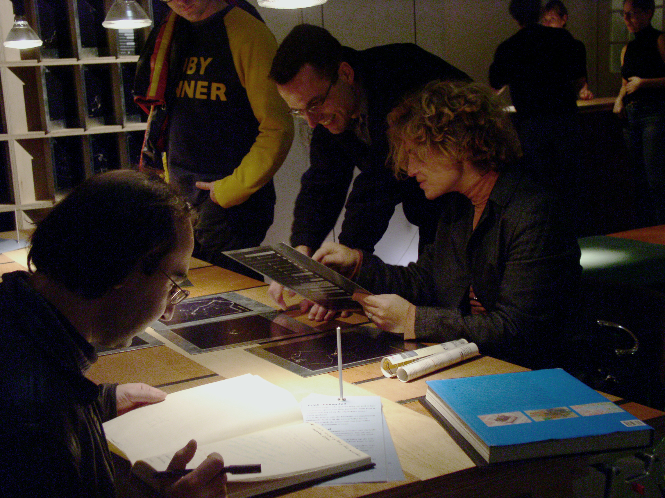 examining prints at the table